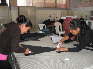Mayan Artisan Studio workers cutting fabric